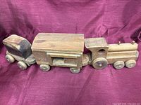 Full view of three connected wooden train cars