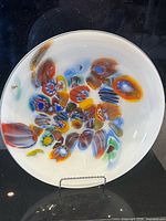 Front view of colourful fused glass platter