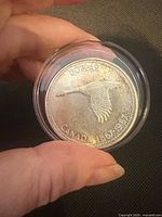 Reverse side showing flying goose design and denomination