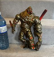 Front view of assembled Molten Man BAF next to water bottle for scale