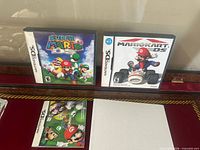 Front view of both Nintendo DS game cases: Super Mario 64 DS and Mario Kart DS