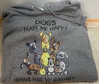 Folded grey hoodie showing full front graphic and text