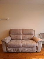 Front view of beige microfiber reclining loveseat
