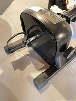 Overall view of mini pedal exercise bike showing housing, LCD display, resistance dial and frame