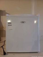 Front view of Master Chef mini refrigerator, power cord visible