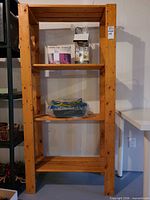 Front view of full pine bookcase showing four shelves and overall construction