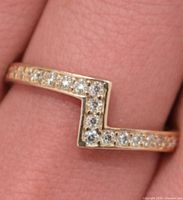 Chevron 10K gold ring with CZ stones on finger