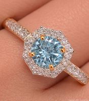 Ring on finger showing overall design and stones