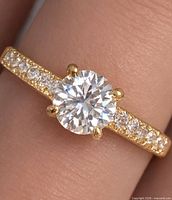 Ring on finger showing centre stone and accent stones