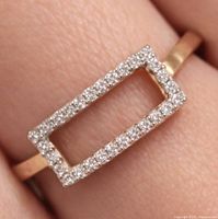 Ring on finger showing open rectangle design and cubic zirconia