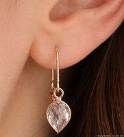 Earring worn on ear showing size and drop design