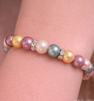 Bracelet worn on wrist showing pearl colours and spacers