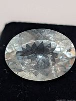 top view of oval aquamarine showing facets and inclusions