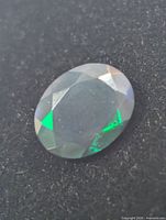 Close-up of black opal showing green play-of-colour