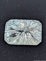 Front view of blue topaz showing fantasy cut facets