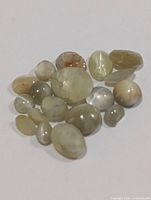 Group of cat's eye cabochon gemstones on white background