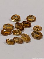 Group of twelve oval faceted golden citrine stones