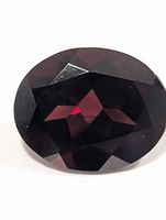 Front view of oval faceted garnet gemstone