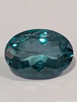 Top view of oval green topaz showing facet arrangement and clarity