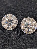 Close-up of both moissanite stones showing faceting and clarity