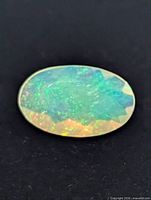 Top view of oval opal showing play-of-color