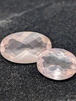 Both rose quartz gemstones on black background