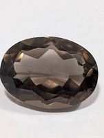 Front view of faceted oval smoky quartz gemstone