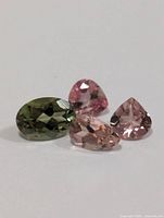 Four loose faceted tourmaline gemstones displayed on white background