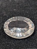 Top view of oval faceted white quartz gemstone