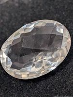 Top view of oval faceted white topaz gemstone