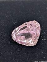 Close-up of the kunzite gemstone showing faceting and color