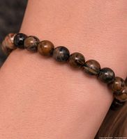 Bracelet worn on wrist showing bead colour and finish