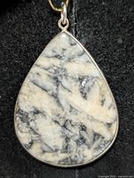 Front view of teardrop Pinolite jasper pendant in silver bezel