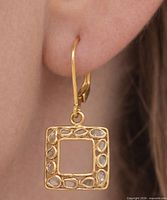 earring worn on ear showing size and drop style