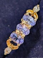 close-up of tanzanite gemstones and accent stones on ring