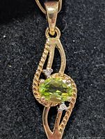Front view of silver pendant showcasing peridot and rope design