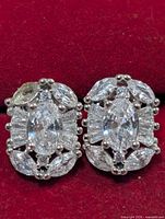 Front view showing cubic zirconia cluster design on red background