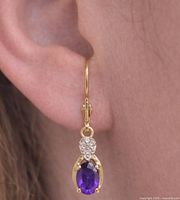 Earring worn to show scale and drop style