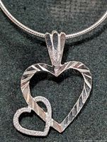 close view of double heart pendant on snake chain