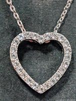 Close-up of heart pendant front showing gemstone setting