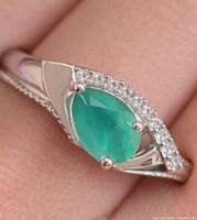 Ring on finger showing green onyx and CZ setting
