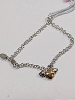 Full view of bracelet showing chain, clasp, and heart-with-wings charm