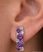 earring worn on ear showing scale and design