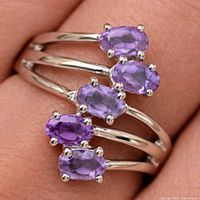 Front view of silver ring showing five amethyst stones