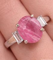 Top view showing oval ruby and accent stones on band