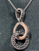 Close-up of pendant front showing marcasite stones and double circle design