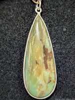 Front view of teardrop pendant showing Andean opal cabochon and silver bezel