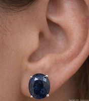 Earring worn on ear showing size and setting