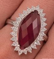 marquise ruby and CZ halo ring on finger