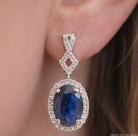 Earring shown worn to illustrate size and dangle design